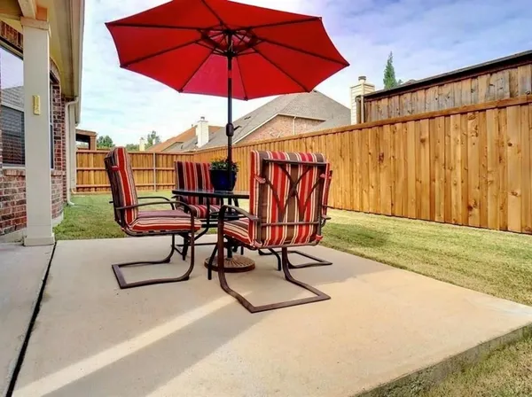 an outdoor space with furniture and umbrella