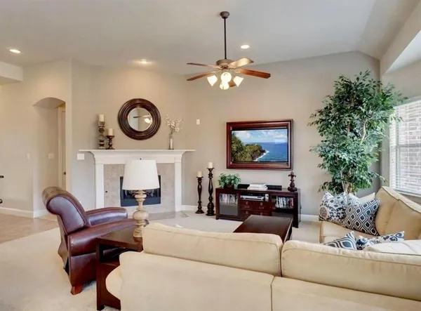 a living room with furniture a clock and a large mirror
