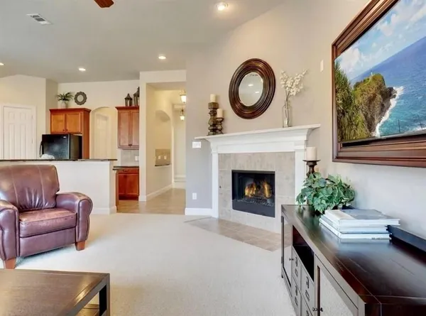 a living room with furniture a fireplace and a wall painting