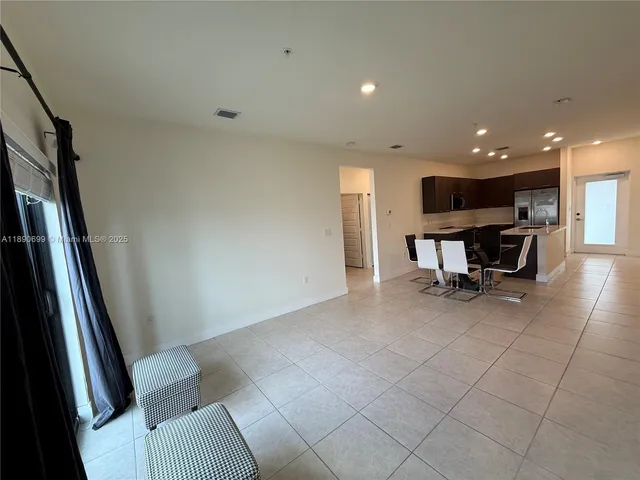 a view of a hallway with seating area
