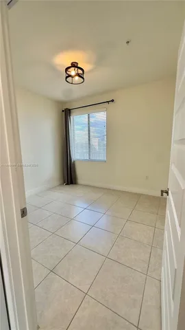 a view of an empty room with a chandelier