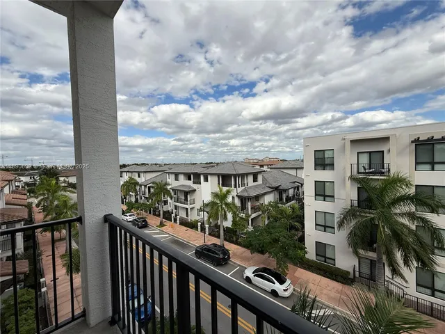a view of a balcony and trees