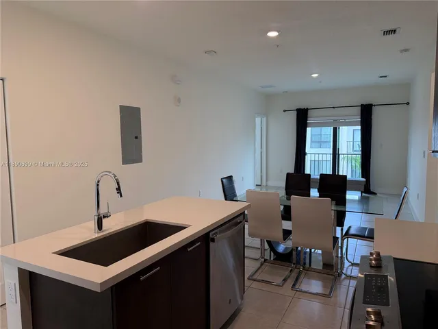 a kitchen with a sink cabinets and wooden floor