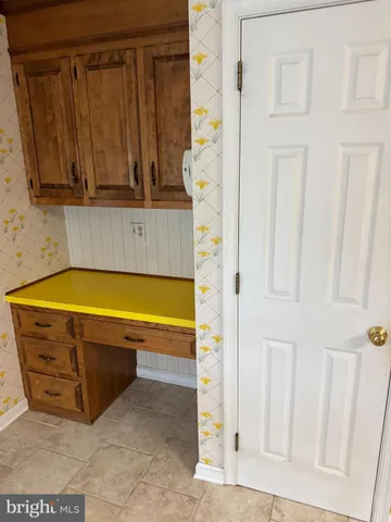 a view of a hallway with wooden floor and a rug