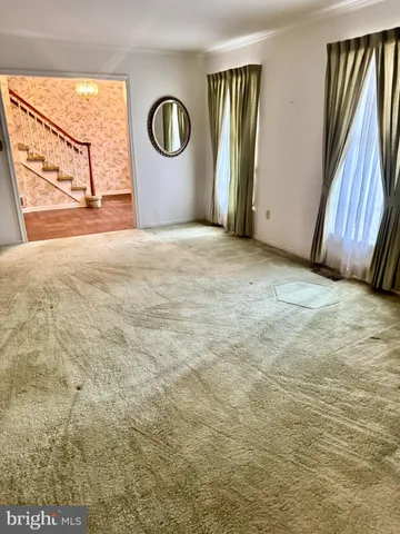 a large room with a fireplace and windows