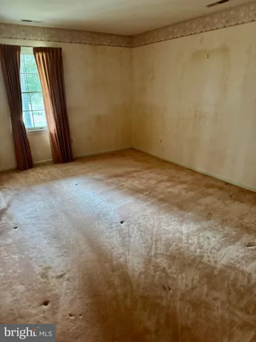 a bed room with a bed and a window