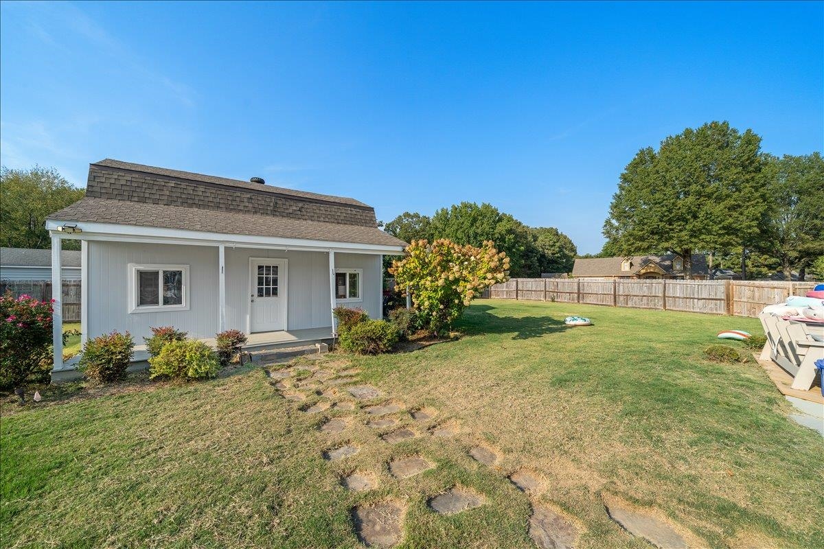 6870 Deerfield Road Bartlett, TN 38135 - Photo 27 of 28 Rear view of house featuring a shingled roof and covered porch