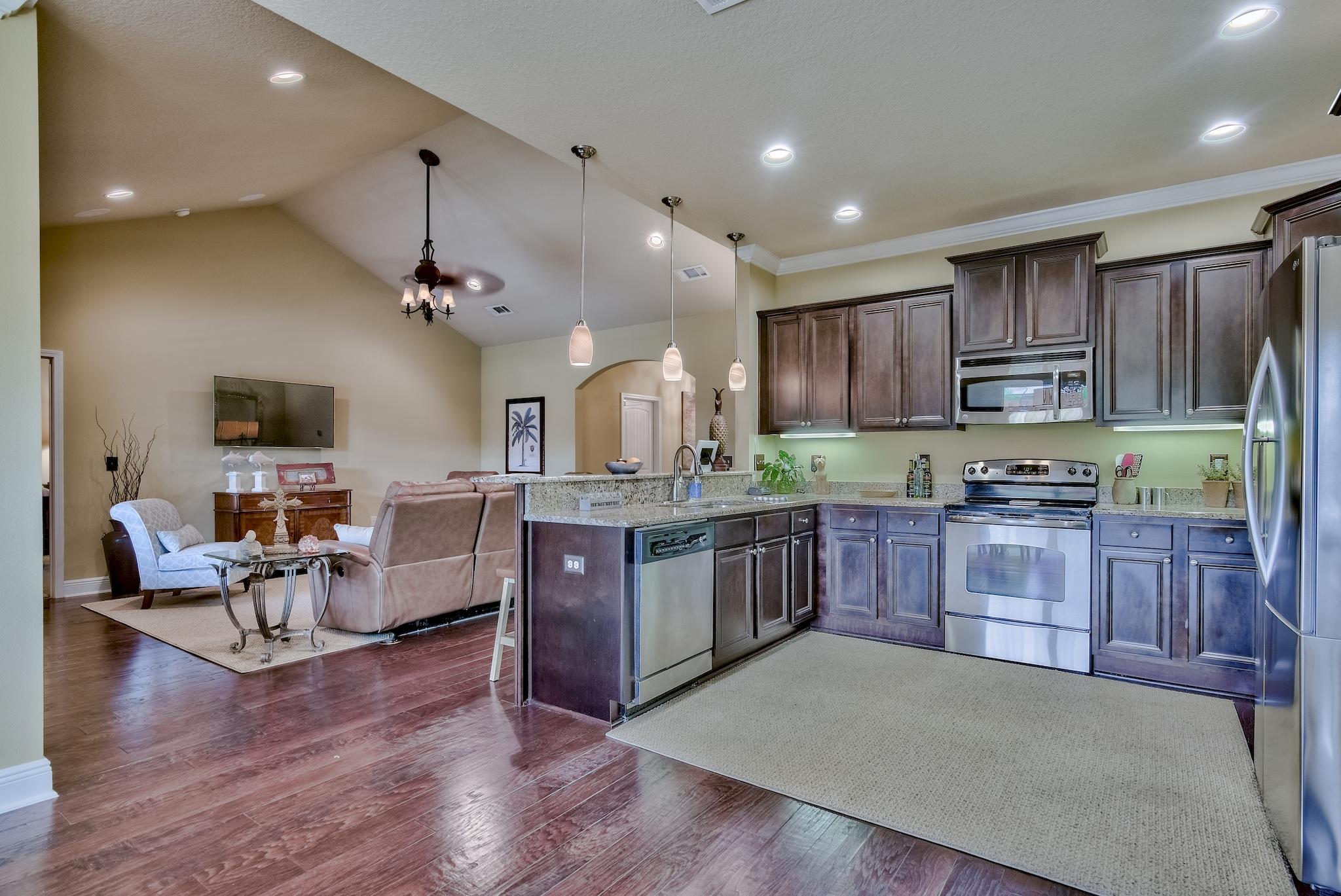 386 Pin Oak Loop Santa Rosa Beach, FL 32459 - Photo 15 of 47 a large kitchen with stainless steel appliances and wooden cabinets