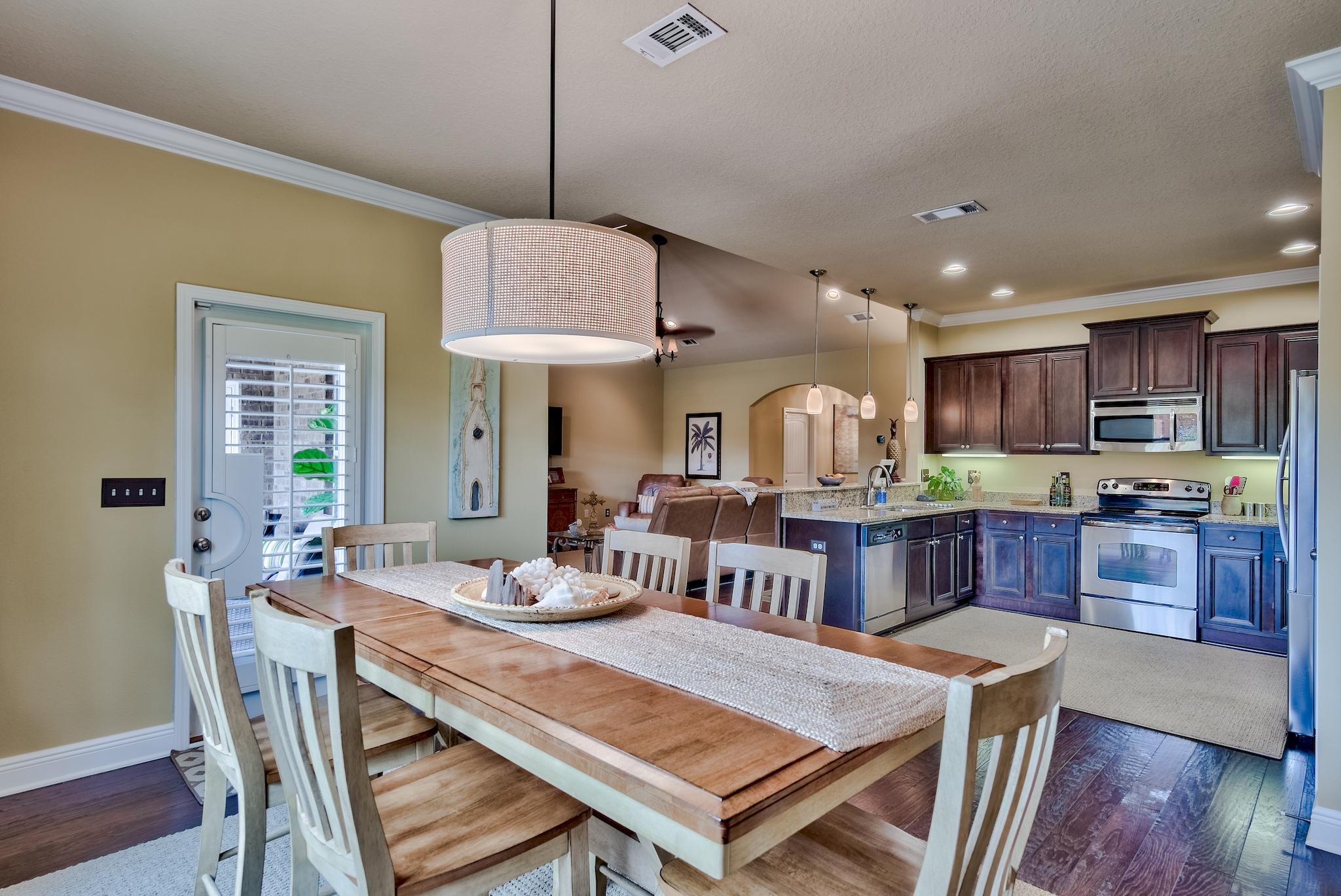 386 Pin Oak Loop Santa Rosa Beach, FL 32459 - Photo 17 of 47 a view of a dining room with furniture window and wooden floor