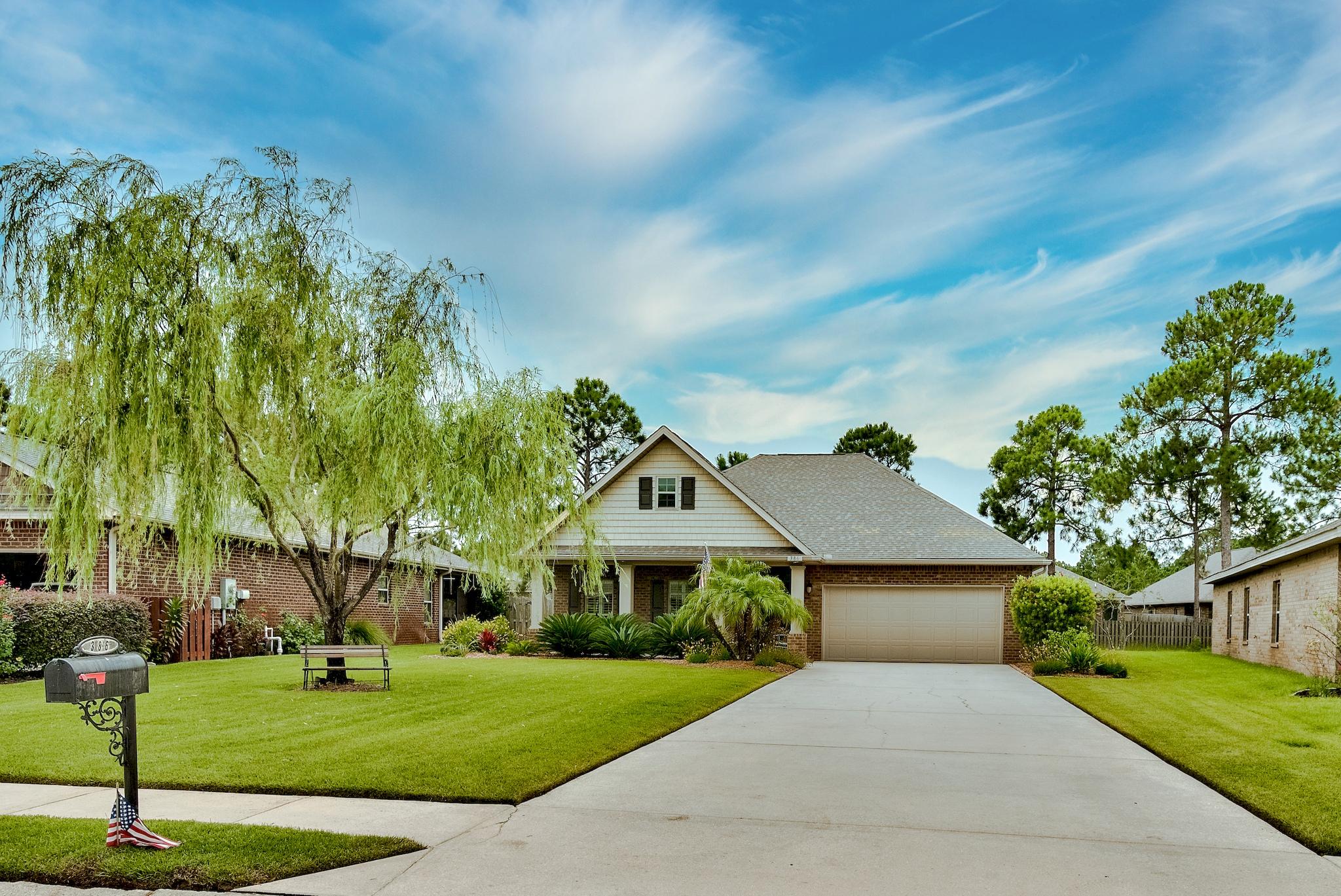 386 Pin Oak Loop Santa Rosa Beach, FL 32459 - Photo 2 of 47 a front view of a house with a yard