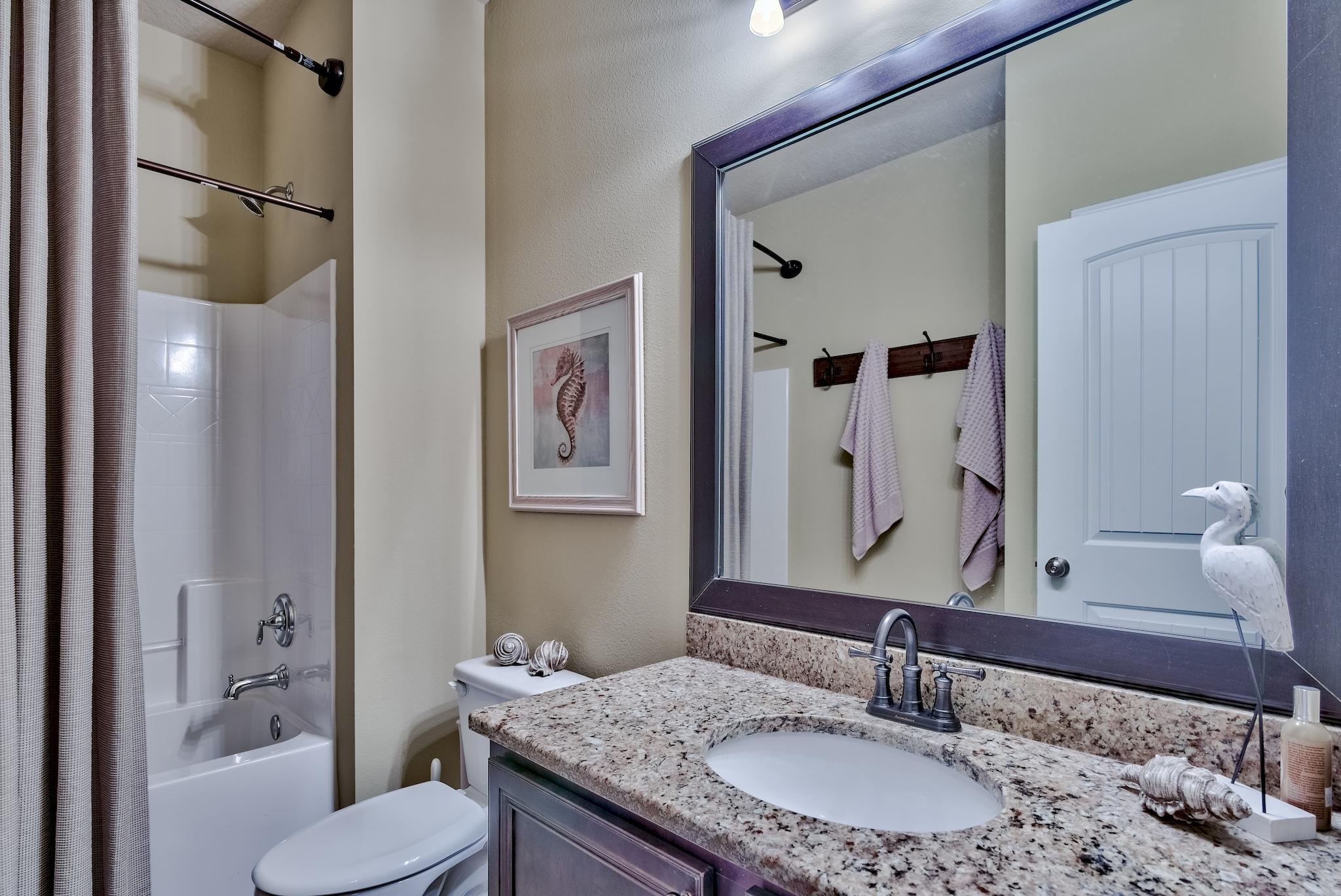 386 Pin Oak Loop Santa Rosa Beach, FL 32459 - Photo 25 of 47 a bathroom with a granite countertop sink mirror and a toilet
