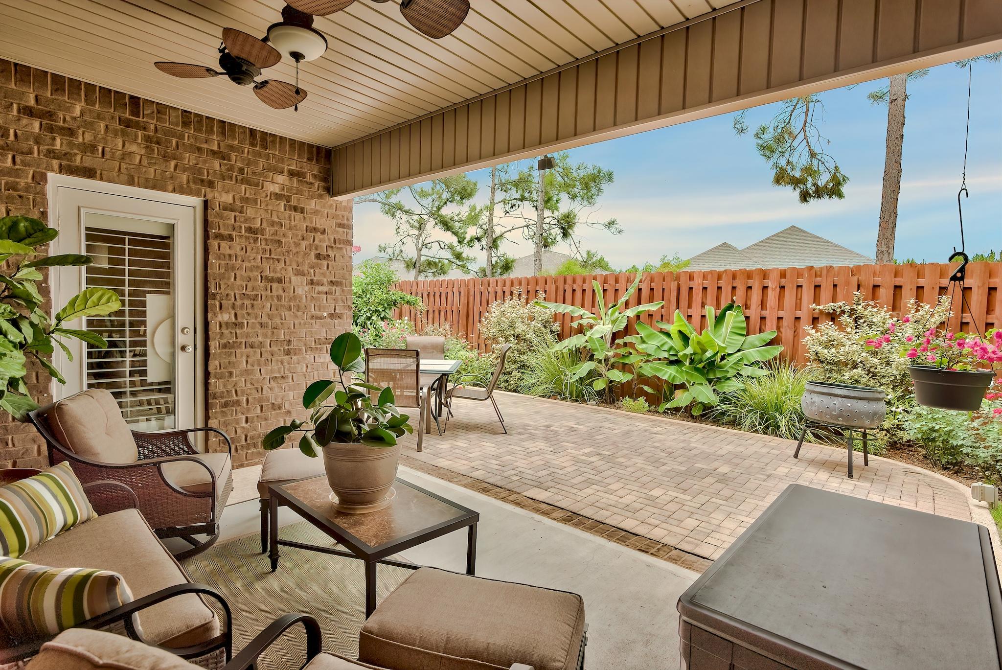 386 Pin Oak Loop Santa Rosa Beach, FL 32459 - Photo 29 of 47 a view of a chairs and table in a patio