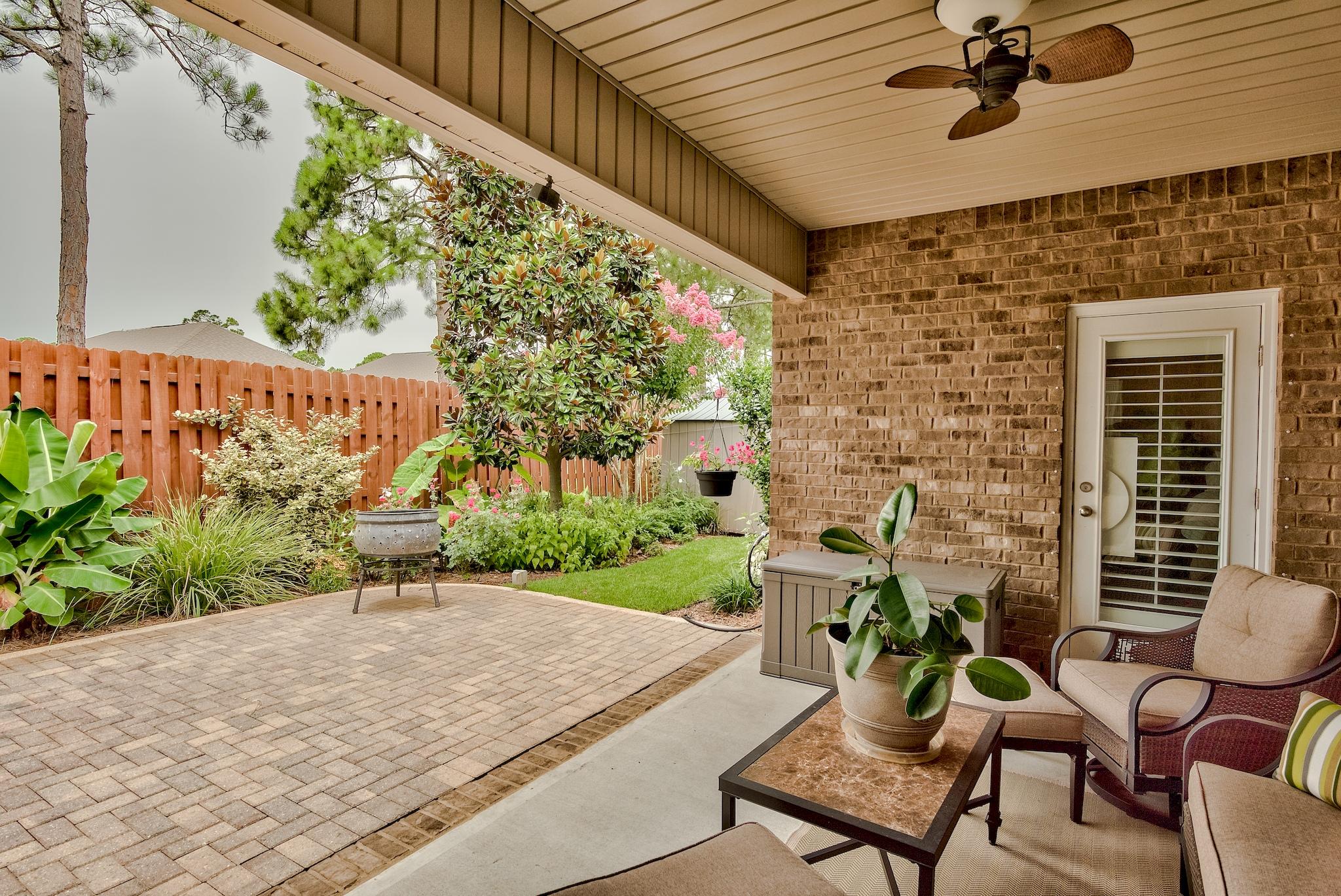 386 Pin Oak Loop Santa Rosa Beach, FL 32459 - Photo 30 of 47 a view of a patio with a table and chairs