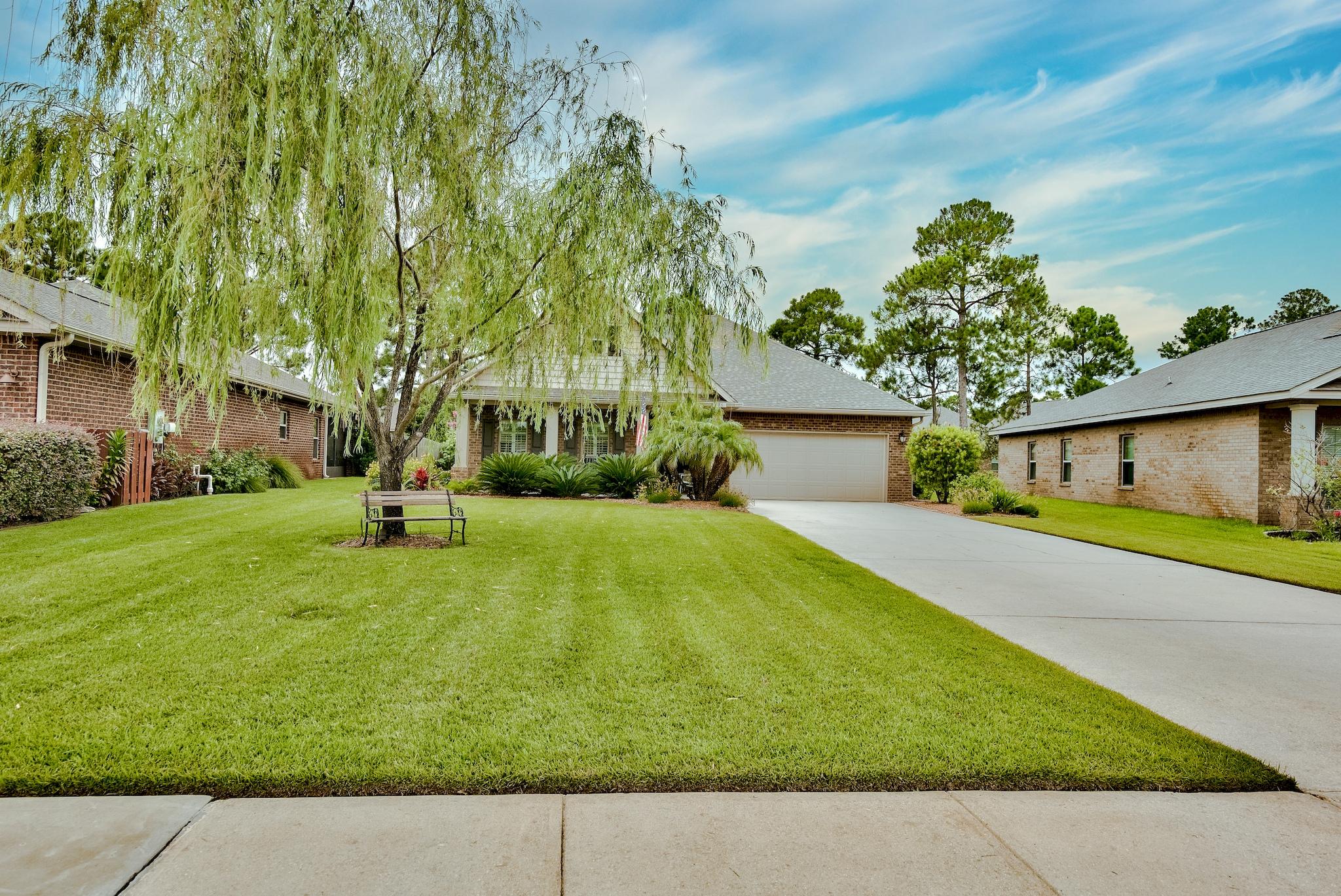 386 Pin Oak Loop Santa Rosa Beach, FL 32459 - Photo 3 of 47 a view of a yard with a house