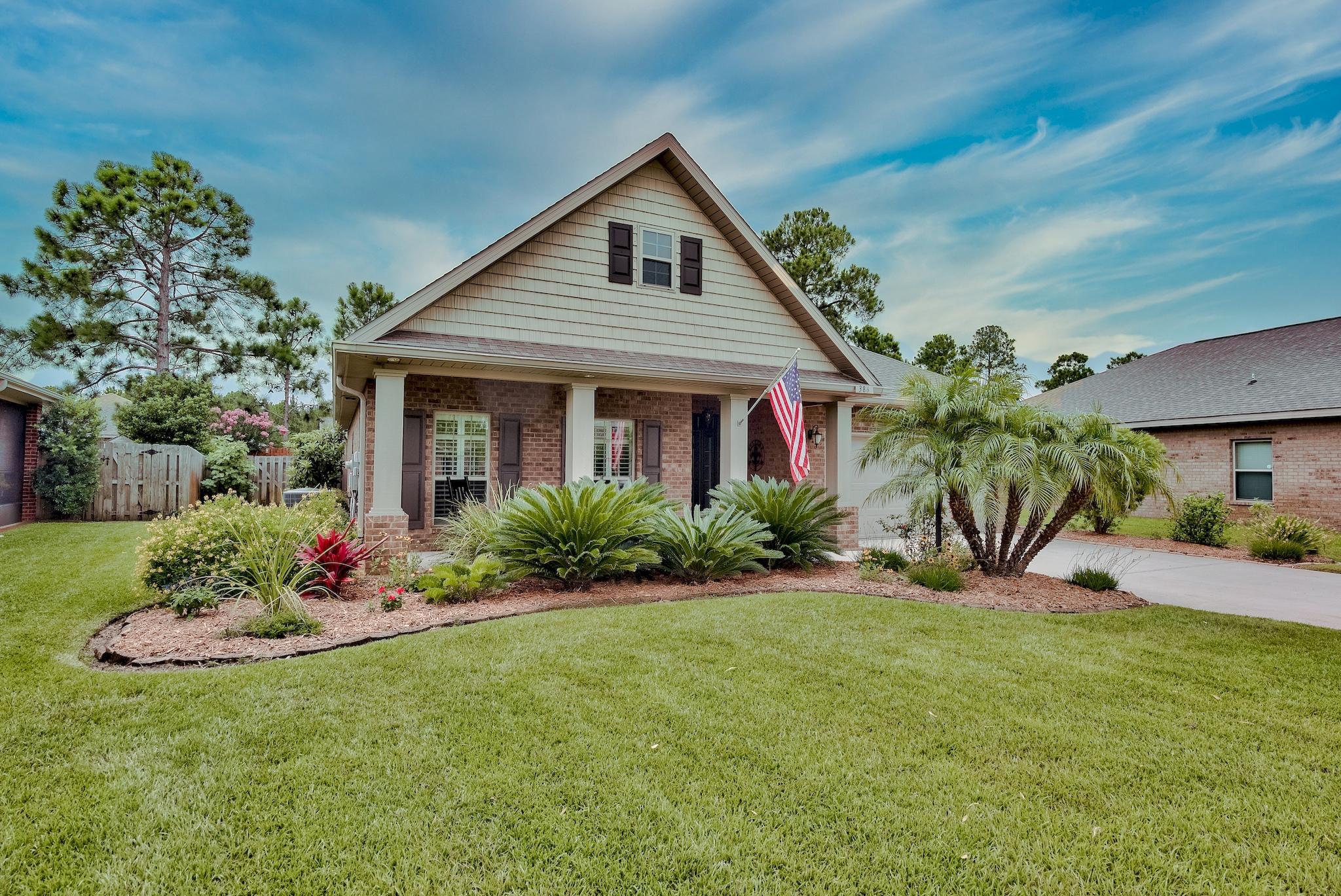 386 Pin Oak Loop Santa Rosa Beach, FL 32459 - Photo 5 of 47 a front view of a house with a yard