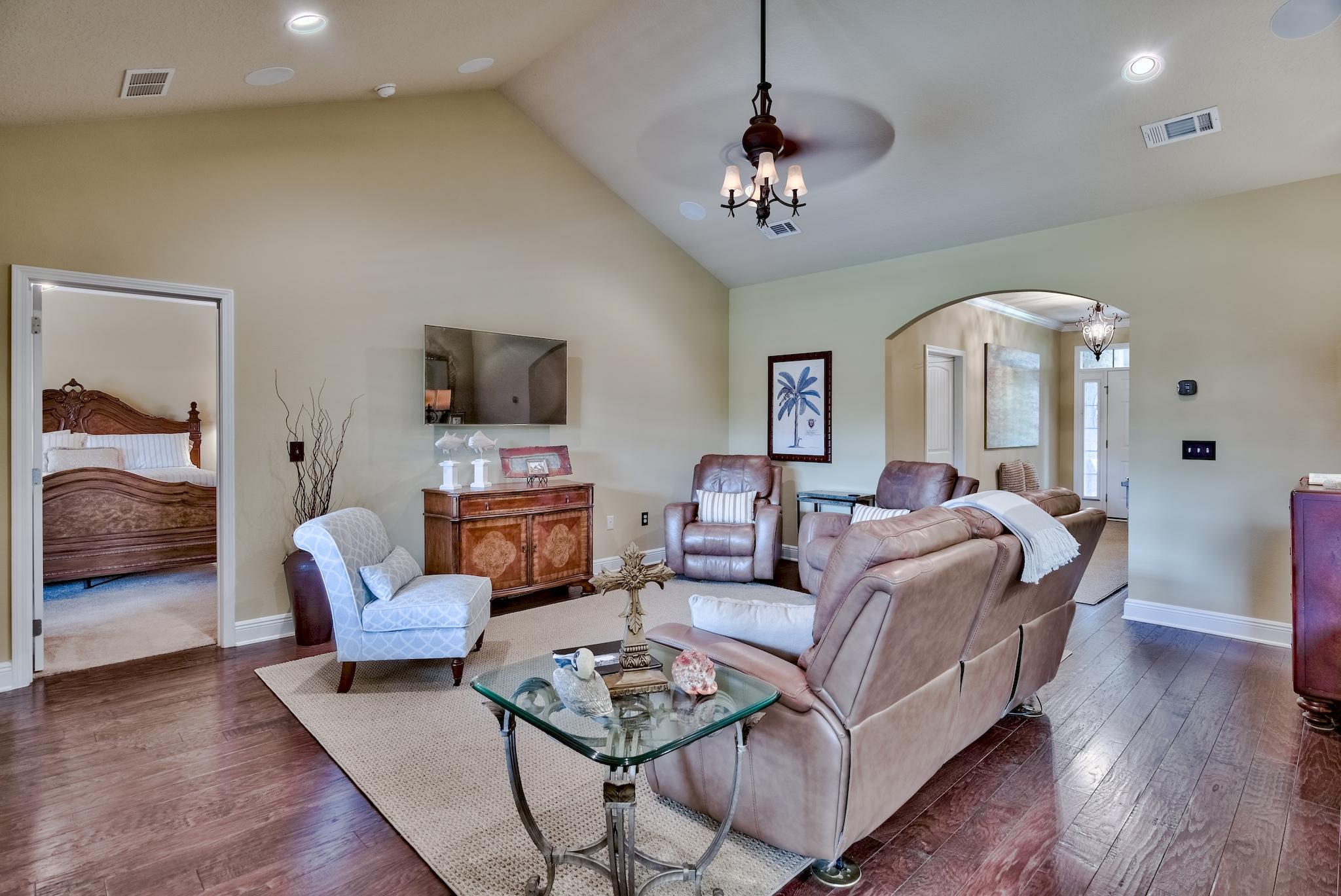 386 Pin Oak Loop Santa Rosa Beach, FL 32459 - Photo 10 of 47 a living room with furniture chandelier and a flat screen tv