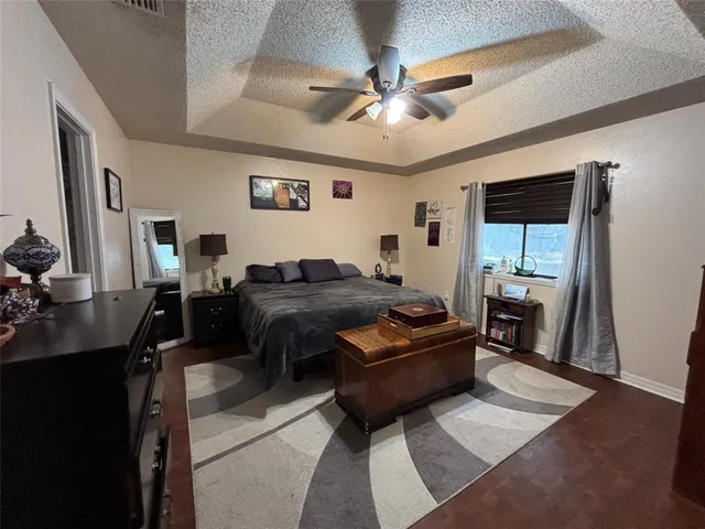a living room with a bed furniture and a flat tv screen