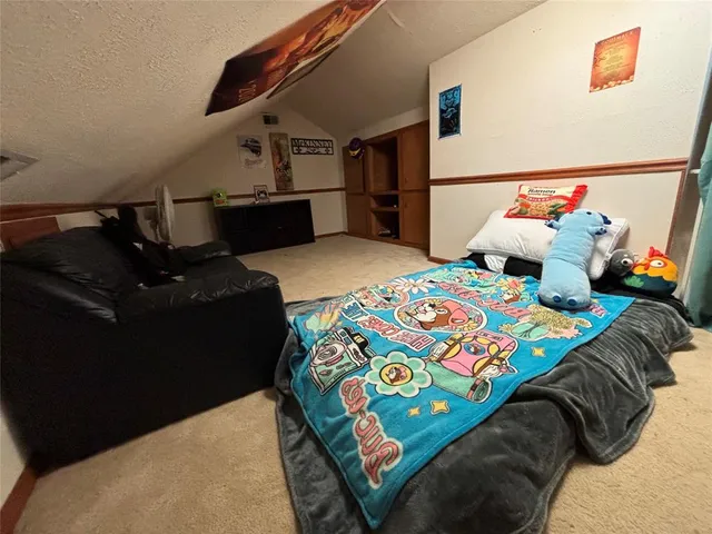 a bedroom with a bed and dresser