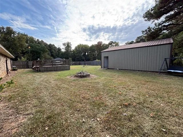 a view of a backyard with sitting area