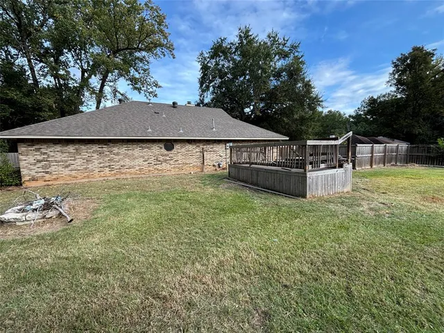 a backyard of a house with table and chairs