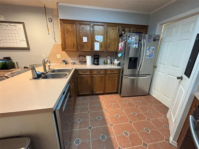 a kitchen with a sink appliances and cabinets