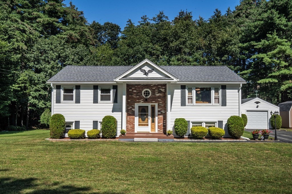 182 Ayer Road Shirley, MA 01464 - Photo 1 of 35 a front view of a house with a garden