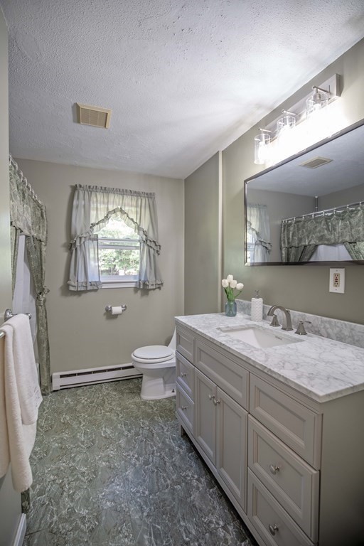 182 Ayer Road Shirley, MA 01464 - Photo 11 of 35 a en suite bathroom with a granite countertop sink and a mirror