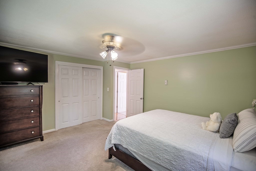 182 Ayer Road Shirley, MA 01464 - Photo 16 of 35 a bedroom with a bed and a flat screen tv