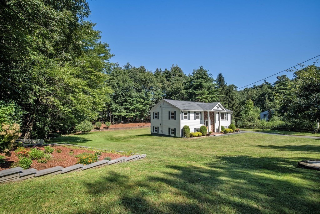 182 Ayer Road Shirley, MA 01464 - Photo 27 of 35 a view of a house with a big yard and large trees