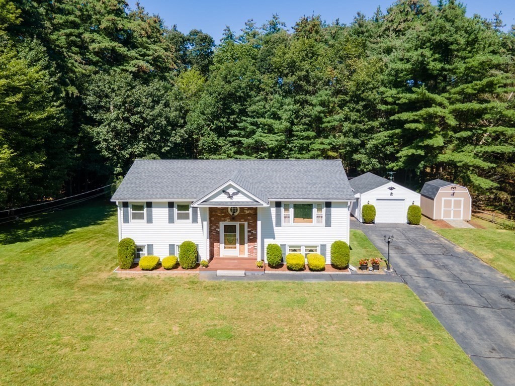 182 Ayer Road Shirley, MA 01464 - Photo 28 of 35 a front view of a house with a yard and trees