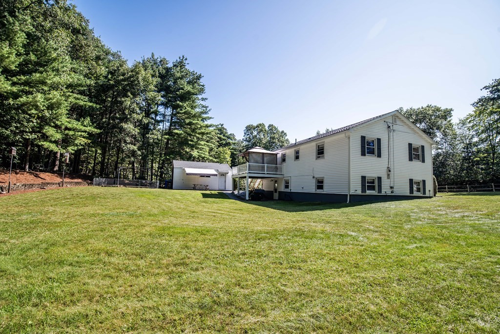182 Ayer Road Shirley, MA 01464 - Photo 30 of 35 a view of a white house with a big yard