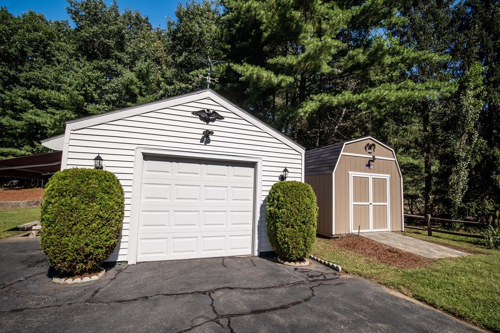182 Ayer Road Shirley, MA 01464 - Photo 32 of 35 a view of a white house with large windows and a small yard