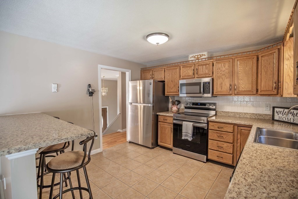 182 Ayer Road Shirley, MA 01464 - Photo 4 of 35 a kitchen with stainless steel appliances granite countertop a stove top oven a sink dishwasher and a refrigerator