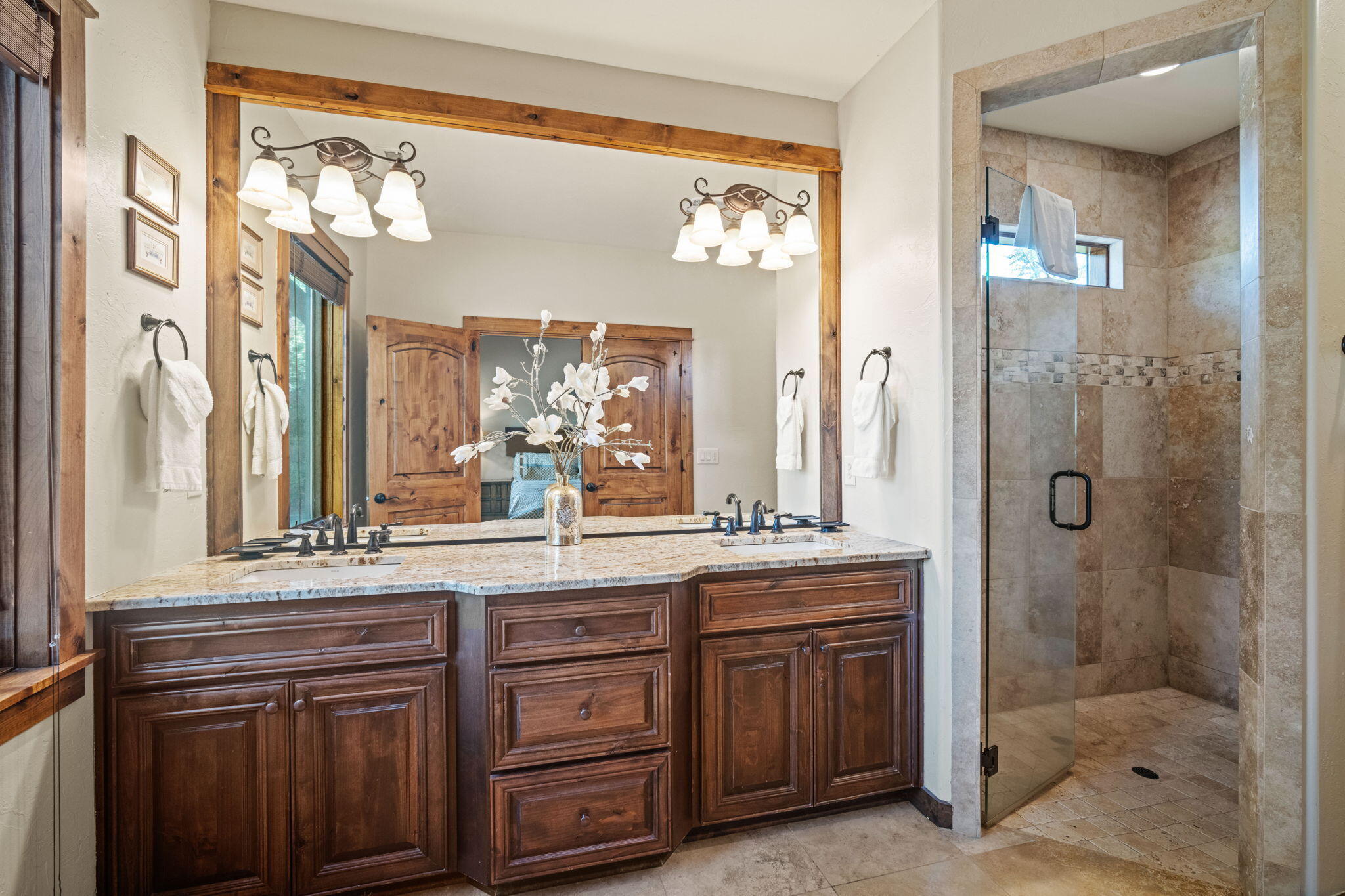 56508 Dancing Rock Loop, Unit 22 Bend, OR 97707 - Photo 29 of 69 a bathroom with a granite countertop sink a mirror and a shower