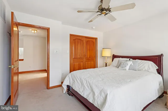 a bedroom with a bed couch and window