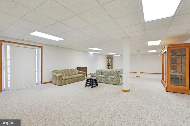 a living room with furniture cabinets and window