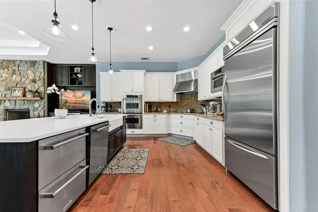 a kitchen with granite countertop white cabinets and white appliances