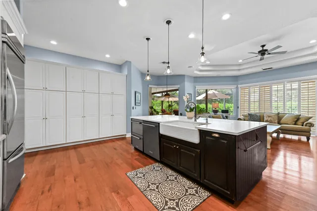 a view of kitchen with stainless steel appliances granite countertop a stove a sink and a refrigerator