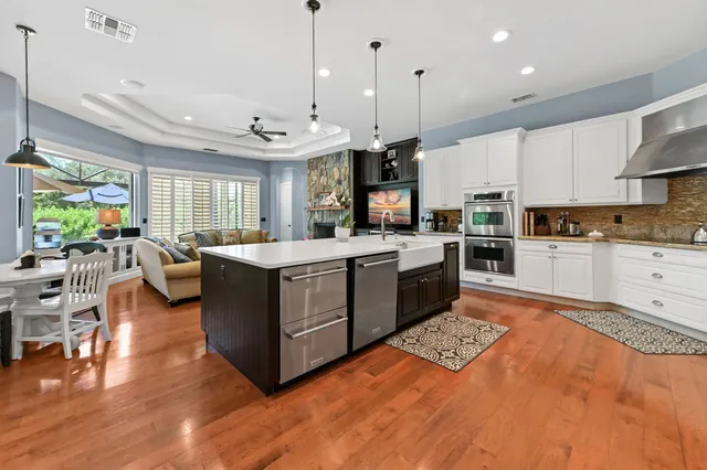 a living room with furniture flat screen tv and a large window