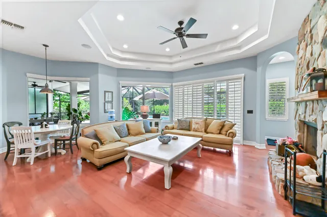 a living room with furniture a fireplace and a flat screen tv