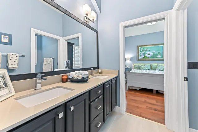 a bathroom with a sink double vanity and a mirror