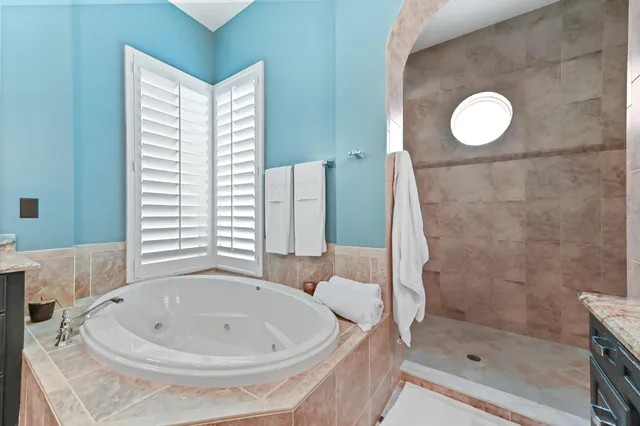 a view of a patio with a table and chairs under an umbrella