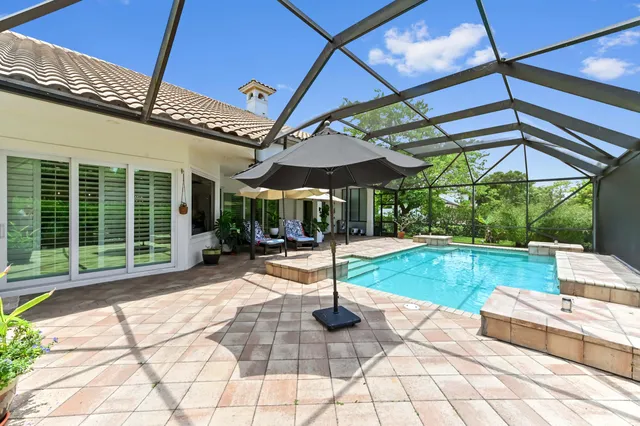 an aerial view of residential houses with outdoor space and swimming pool