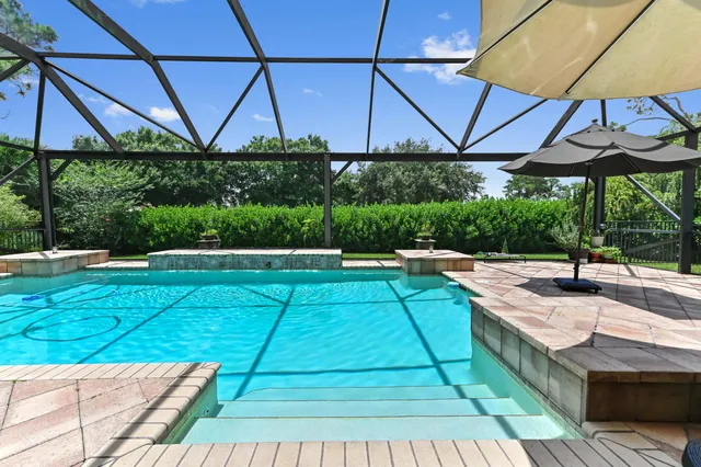 an aerial view of residential houses with outdoor space and swimming pool