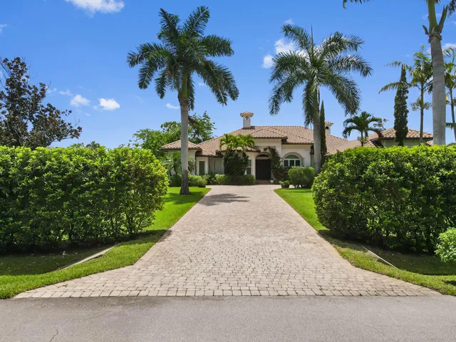 an aerial view of residential houses with outdoor space and swimming pool