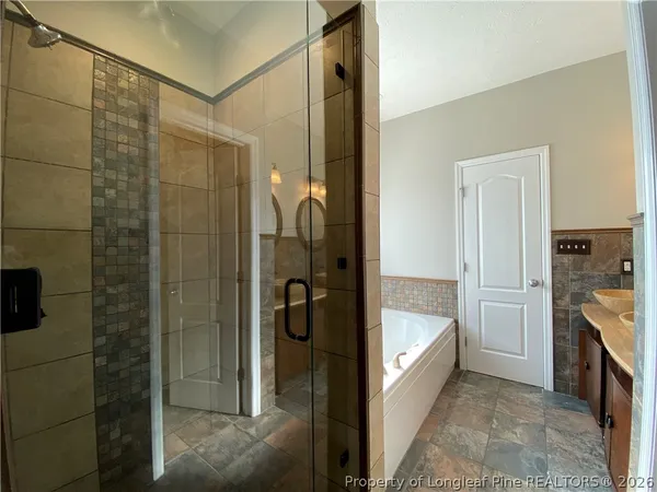 a bath tub sitting in a bathroom next to a window