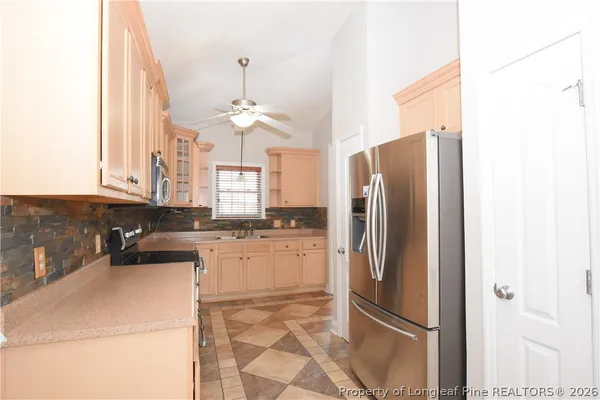 a kitchen with stainless steel appliances white cabinets and a stove a sink