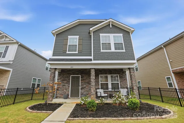 a front view of a house with garden