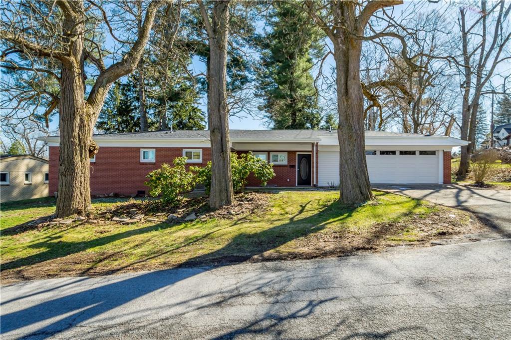 a view of house with backyard and tree