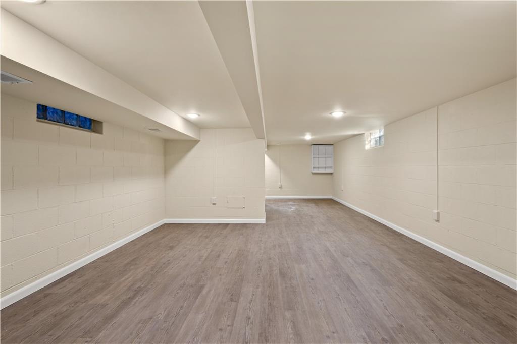 27 North Johnson Road Houston, PA 15342 - Photo 21 of 25 an empty room with wooden floor and windows